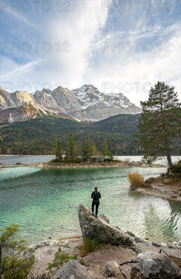 Young woman standing on a rock on the shore