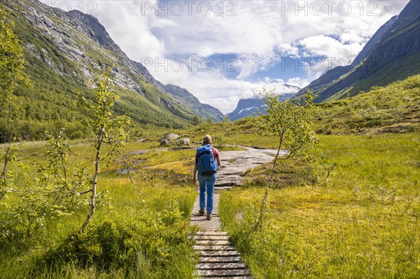 Hiker on a hiking trail to Innerdalstarnet