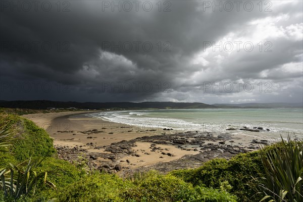 View of sandy beach and sea at Curio Bay