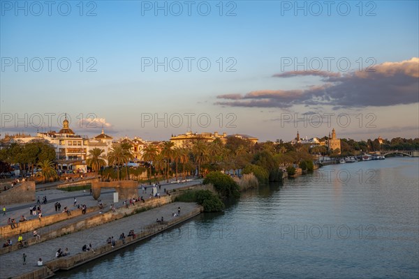 Waterfront Muelle de la sal at the river Rio Guadalquivir with Monumento a la Tolerancia