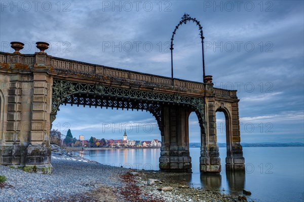 Castle footbridge after sunset and Friedrichshafen in the distance