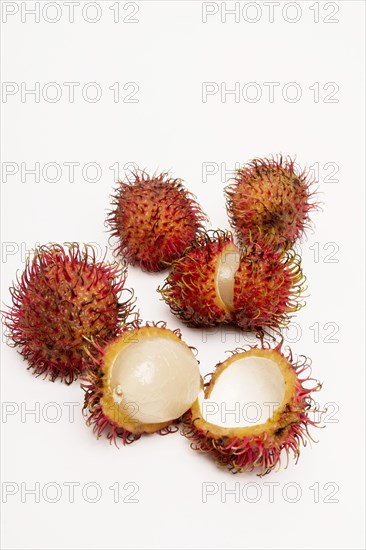 Rambutan whole and peeled on white background