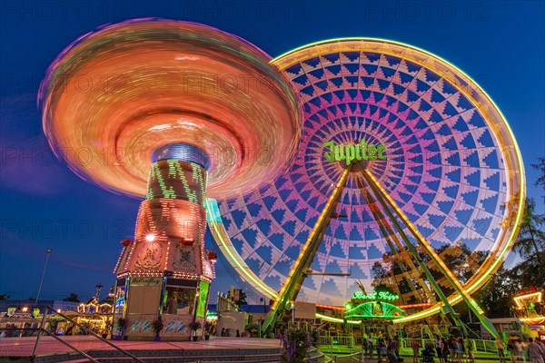 Chain carousel and Ferris wheel at night