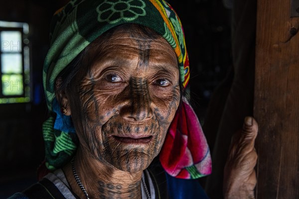 Chin woman with spiderweb tattoo