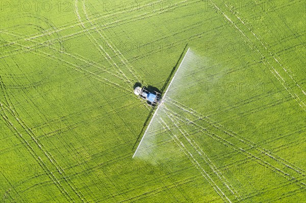 Tractor spraying fungicide onto the rice fields