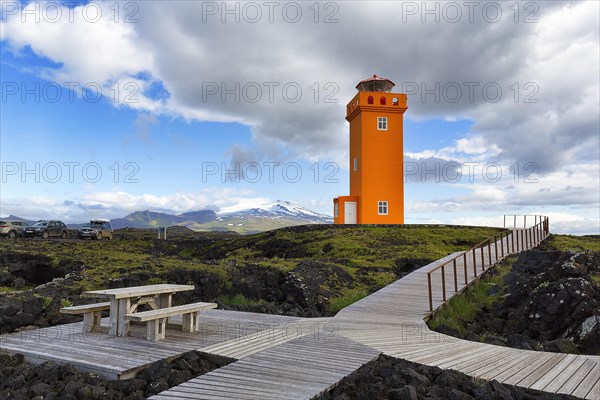 Orange lighthouse Skalasnagaviti or Svoertuloft with wooden boardwalk