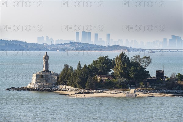 Buddha statue on an island with Xiamen in the background