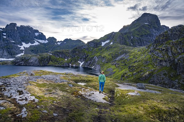 Hiker on a hiking trail to Hermannsdalstinden