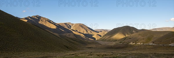 Barren mountain landscape with tufts of grass