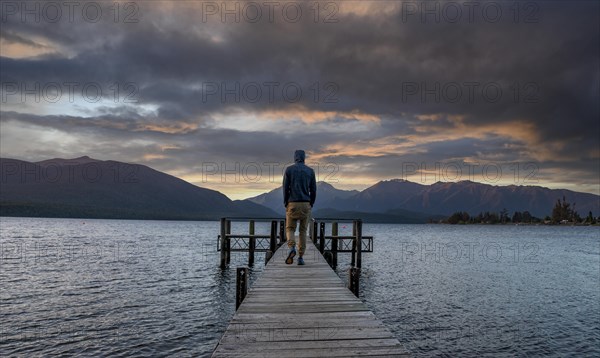 Juger man on jetty at lake