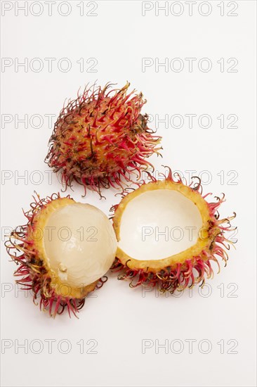 Rambutan whole and peeled on white background