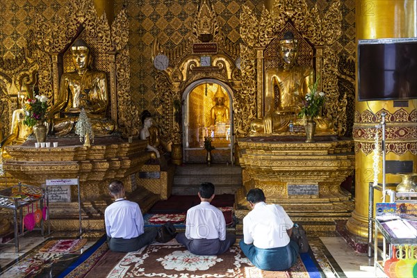 Pilgrims praying in the Shwedagon pagoda