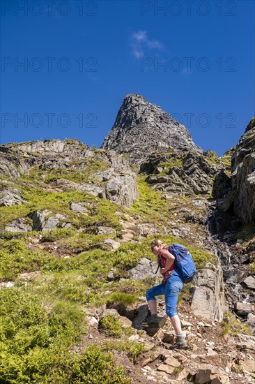 Hiking on a steep trail to Innerdalstarnet