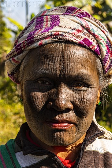 Yin-Du Chin woman with a complete black tattoed face