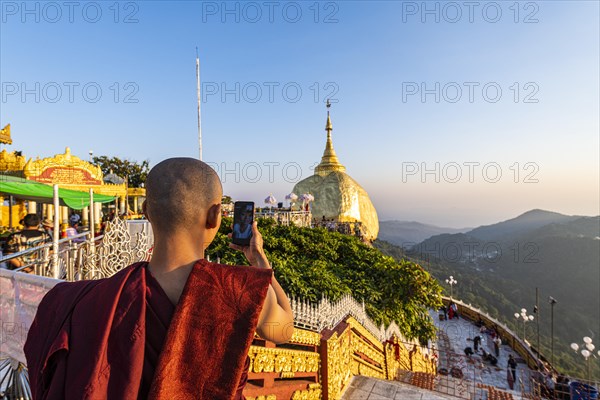 Monk photographing the Kyaiktiyo Pagoda