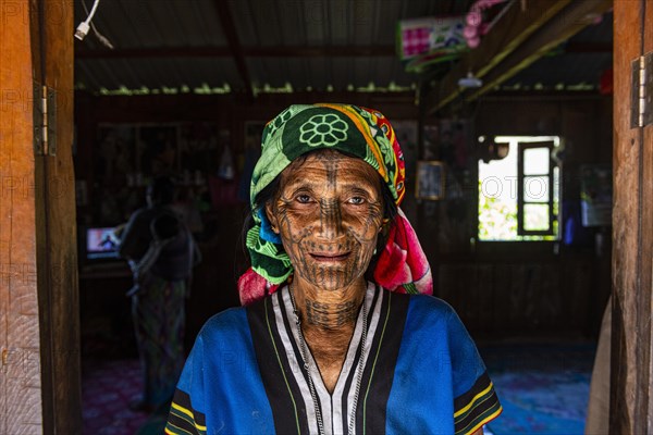 Chin woman with spiderweb tattoo