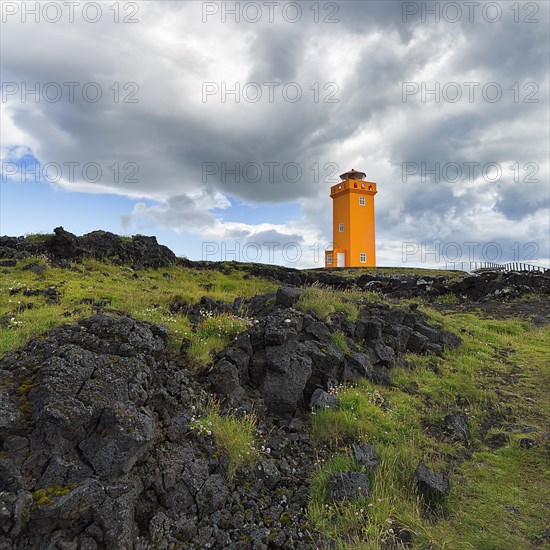 Orange lighthouse Skalasnagaviti or Svoertuloft at cliff