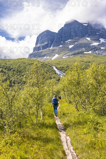 Hiker on a hiking trail to Innerdalstarnet