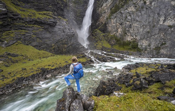 Hiker standing by river Driva