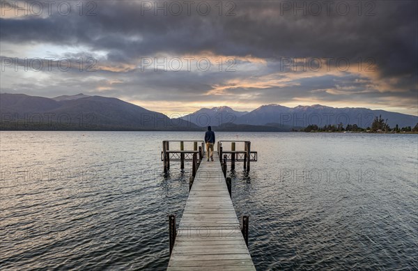 Juger man on jetty at lake