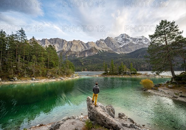 Young man standing on a rock on the shore