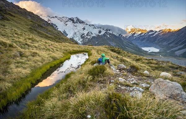 Hiker sitting at a mountain lake