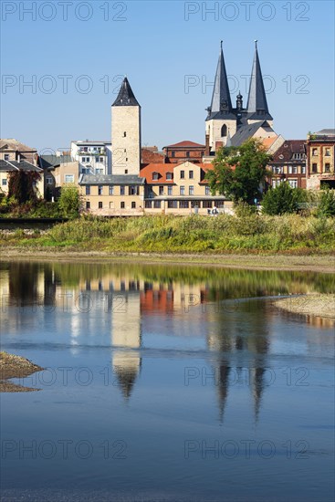 Witch tower and Stephani church reflected in the river Saale