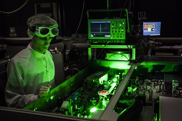 PhD student during his research work adjusting his experimental setup