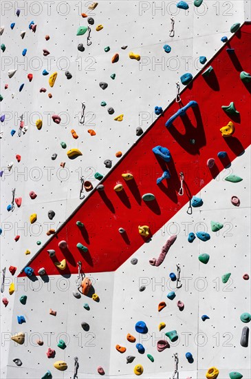 Handles hooks and eyes on a climbing wall