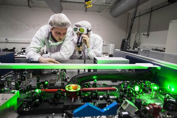 PhD student during his research work adjusting his experimental setup