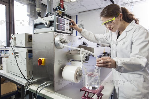 Doctoral student during her research work on a film drawing bench at the Institute for Pharmaceutical Technology and Biopharmacy at Heinrich-Heine-University Duesseldorf