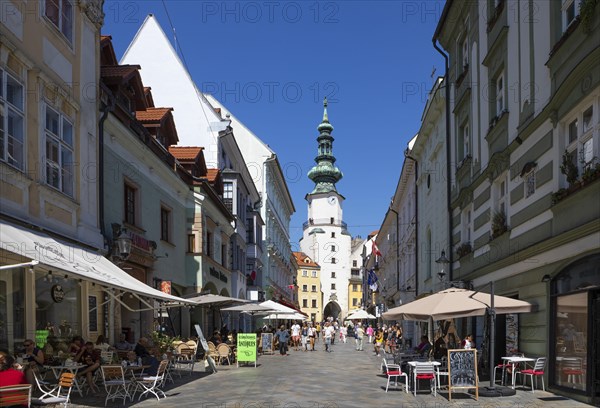 Pedestrian zone with restaurants in Michalska Street with Michael's Gate