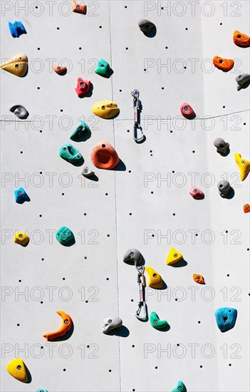Handles hooks and eyes on a climbing wall