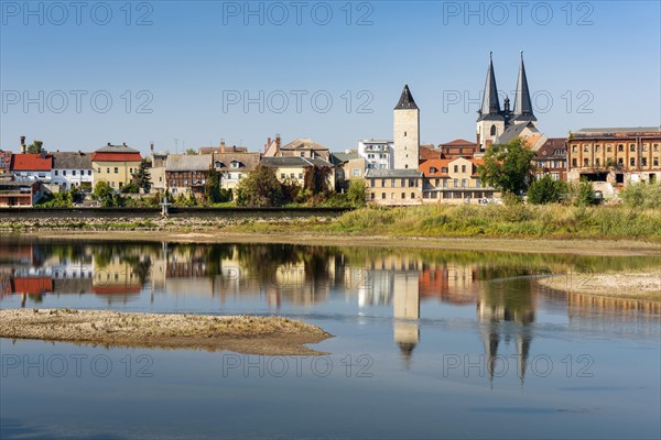 Old town with witch tower and Stephani church reflected in the river Saale