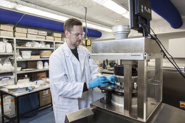 Scientists during their research work on a tablet press at the Institute for Pharmaceutical Technology and Biopharmacy at Heinrich-Heine-University Duesseldorf