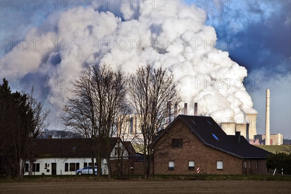 Residential building at Rather Muehle in front of Neurath lignite-fired power plant