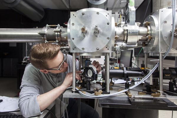 PhD student during his research work adjusting his experimental setup