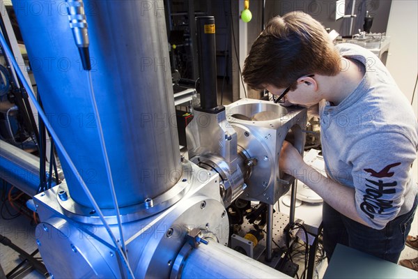 PhD student during his research work adjusting his experimental setup