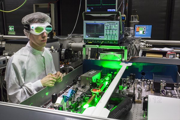 PhD student during his research work adjusting his experimental setup