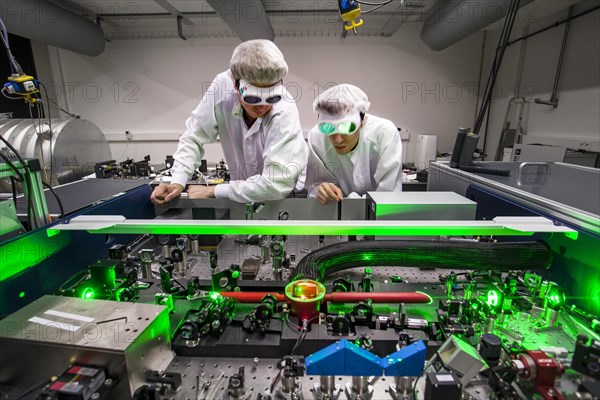 PhD student during his research work adjusting his experimental setup