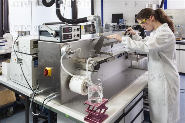 Doctoral student during her research work on a film drawing bench at the Institute for Pharmaceutical Technology and Biopharmacy at Heinrich-Heine-University Duesseldorf