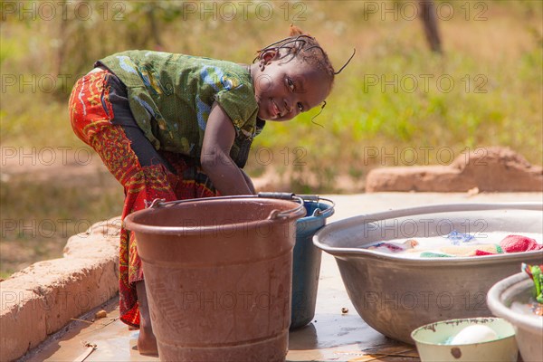 African child doing laundry