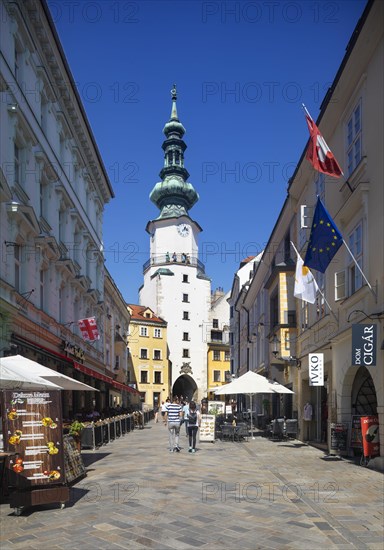 Pedestrian zone with restaurants in Michalska Street with Michael's Gate