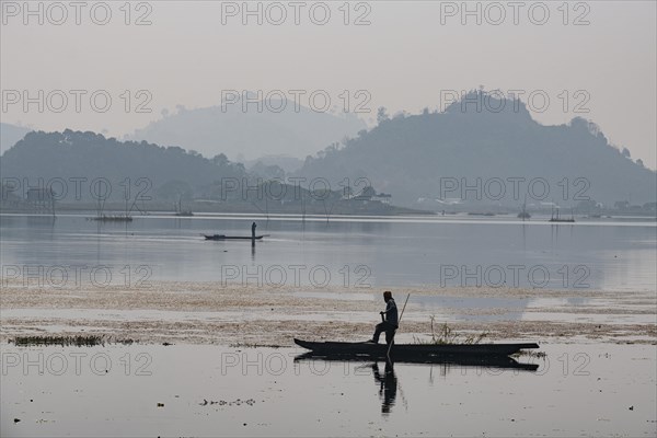 Fisherman in his canoe fishing