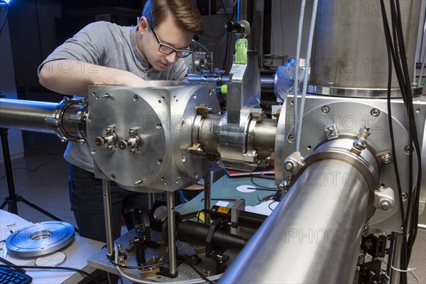 PhD student during his research work adjusting his experimental setup