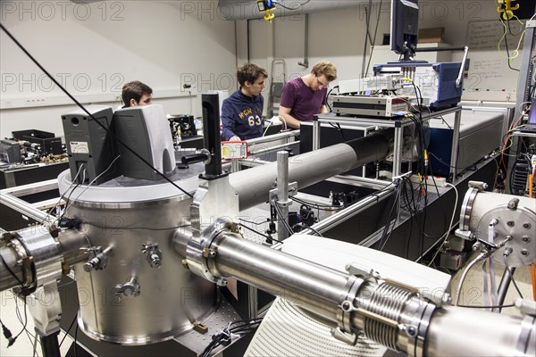 PhD student during his research work adjusting his experimental setup