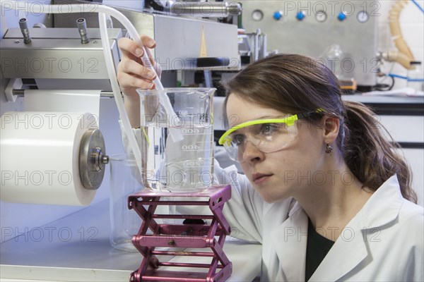 Doctoral student during her research work on a film drawing bench at the Institute for Pharmaceutical Technology and Biopharmacy at Heinrich-Heine-University Duesseldorf