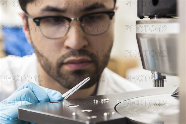 Scientists during their research work on a tablet press at the Institute for Pharmaceutical Technology and Biopharmacy at Heinrich-Heine-University Duesseldorf