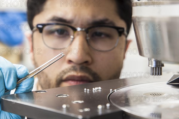 Scientists during their research work on a tablet press at the Institute for Pharmaceutical Technology and Biopharmacy at Heinrich-Heine-University Duesseldorf