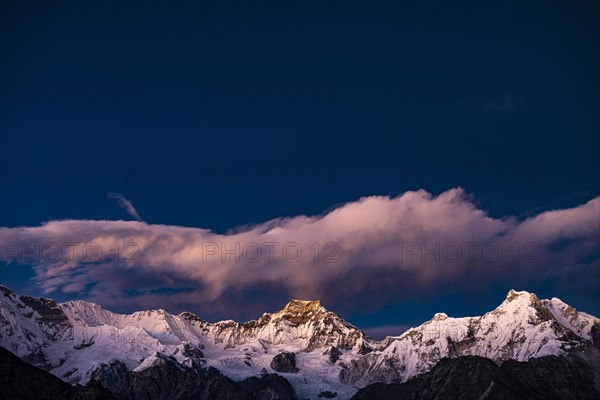View in the evening light from Renjo La Pass 5417 m to the east on Himalaya with Gyachung Kang